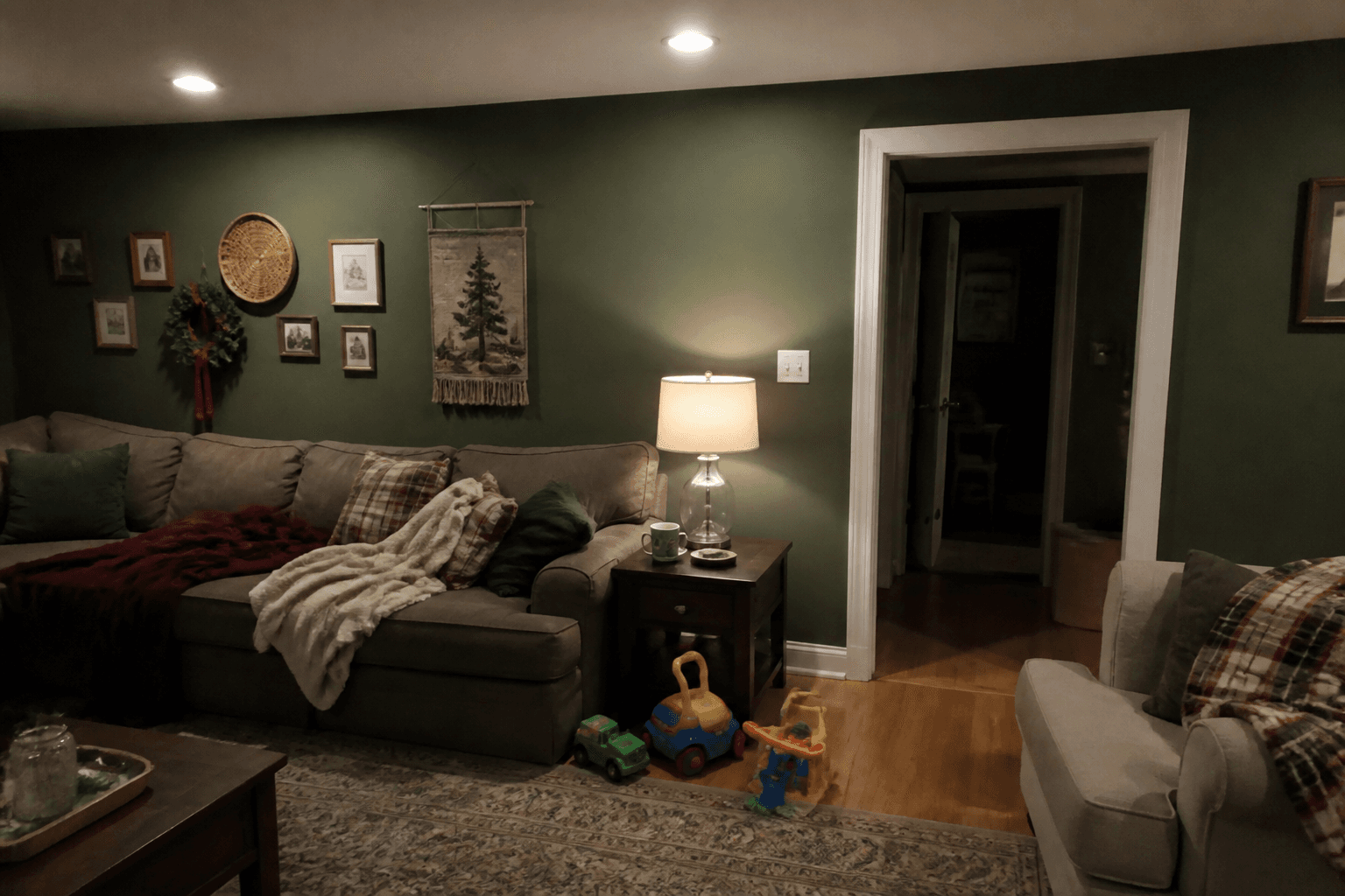Living room at night with a holiday elf on a shelf.